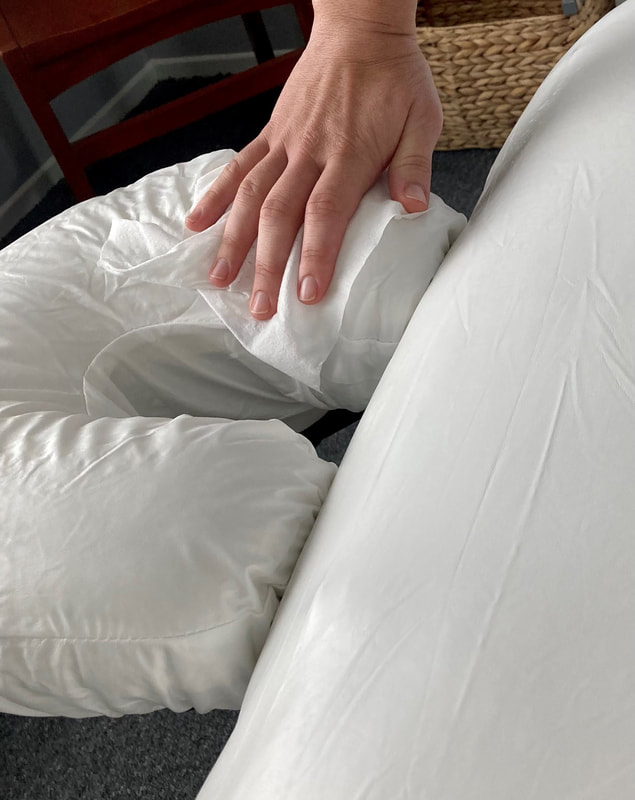 Image of waterproof massage table surface being disinfected with wipes