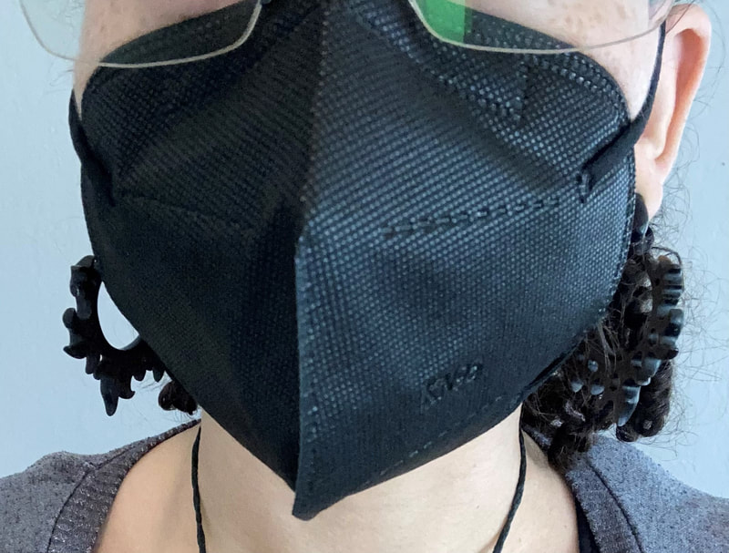 Cropped image of Krystal wearing black KN95 mask